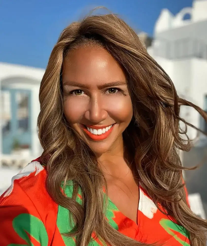 Portrait of Lisa Stone smiling, by the sea